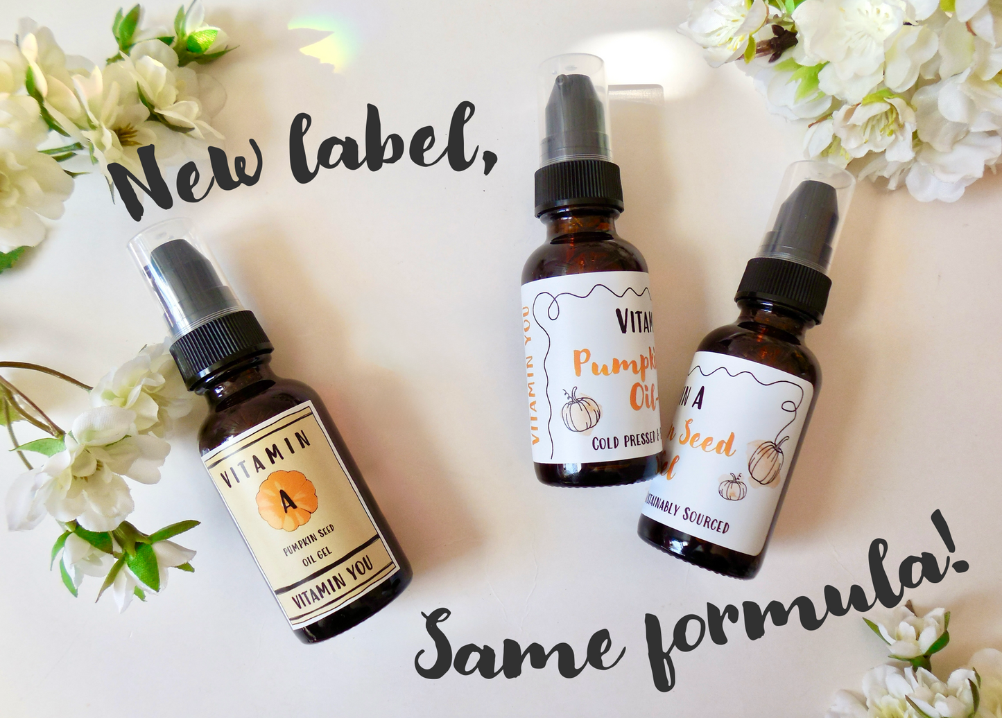 New label, same formula warning with the old bottle on the left and the new bottles on the right surrounded by flowers.