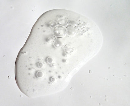 Close up image of soft clear serum with bubbles.