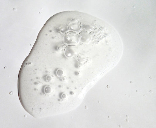 Close up image of soft clear serum with bubbles.
