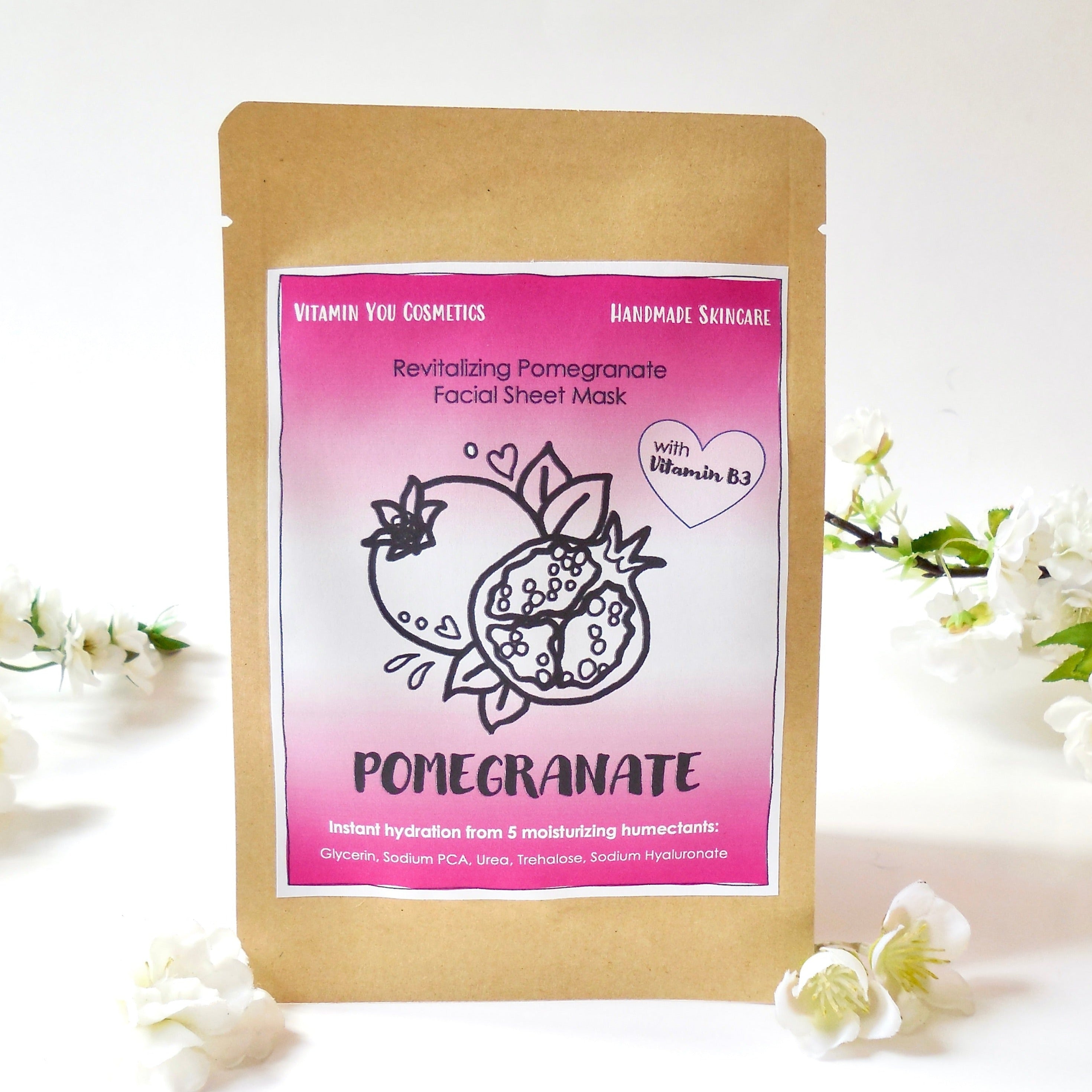 Vitamin You Pomegranate Facial Sheet Mask with a handdrawn pomegranate pink design on an ecofriendly kraft satchel.