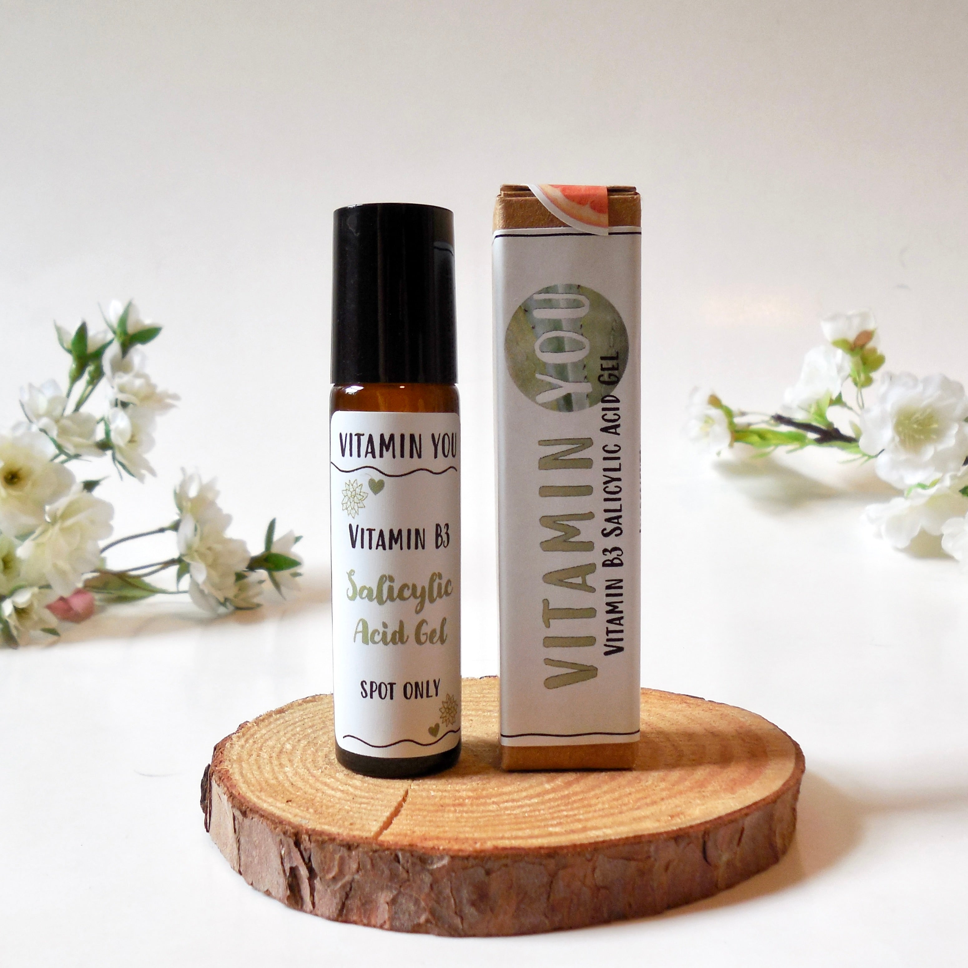 Vitamin You Vitamin B3 Salicylic Acid Gel product as shown as a small roller bottle next to a small box.