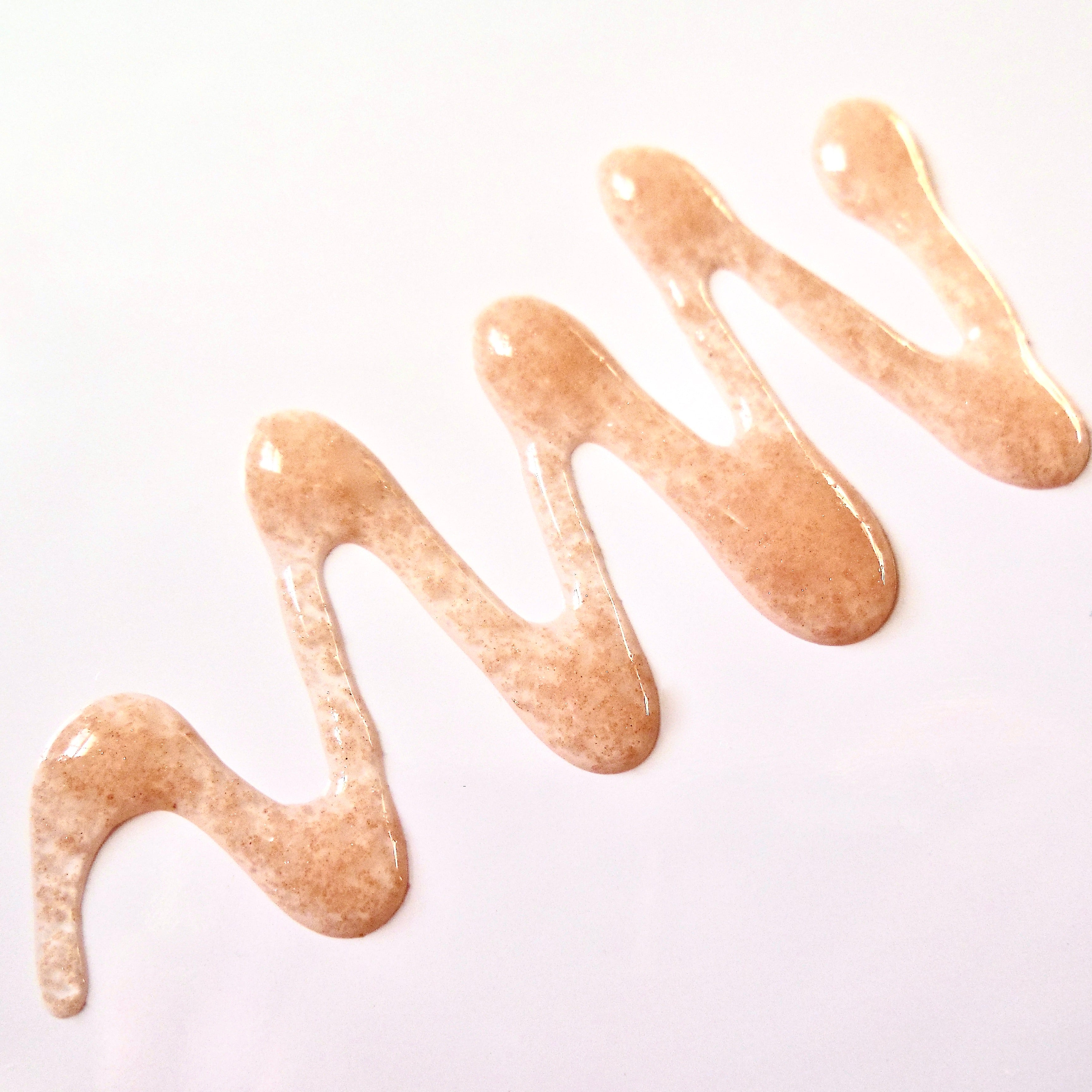 Close up shot of pink strawberry butter in niacinamide gel texture 