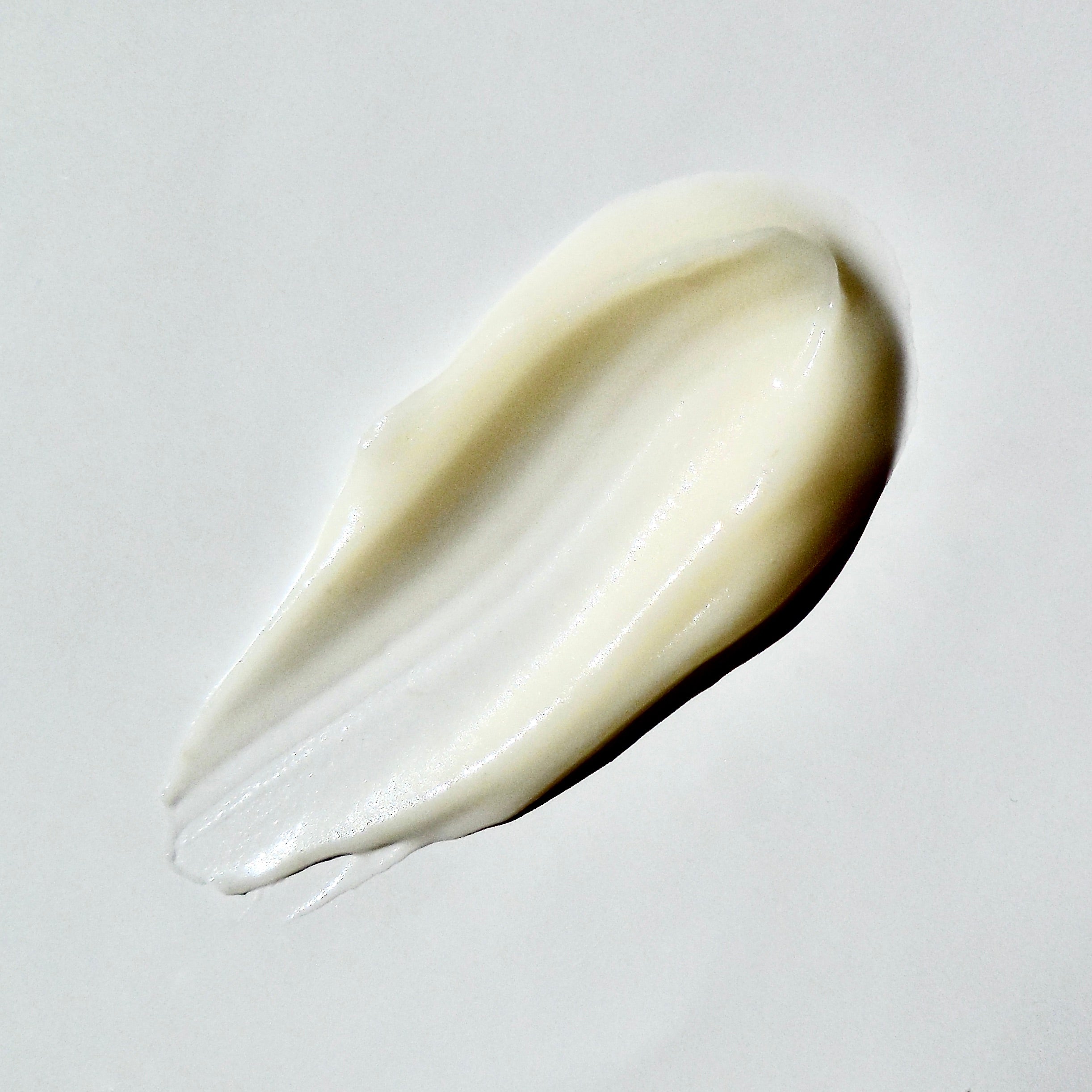 Close up swatch of a pumpkin cream on a white background