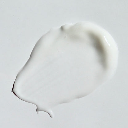 Close up image of soothing oatmeal cream swipe on a white background