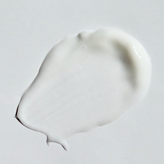 Close up image of soothing oatmeal cream swipe on a white background