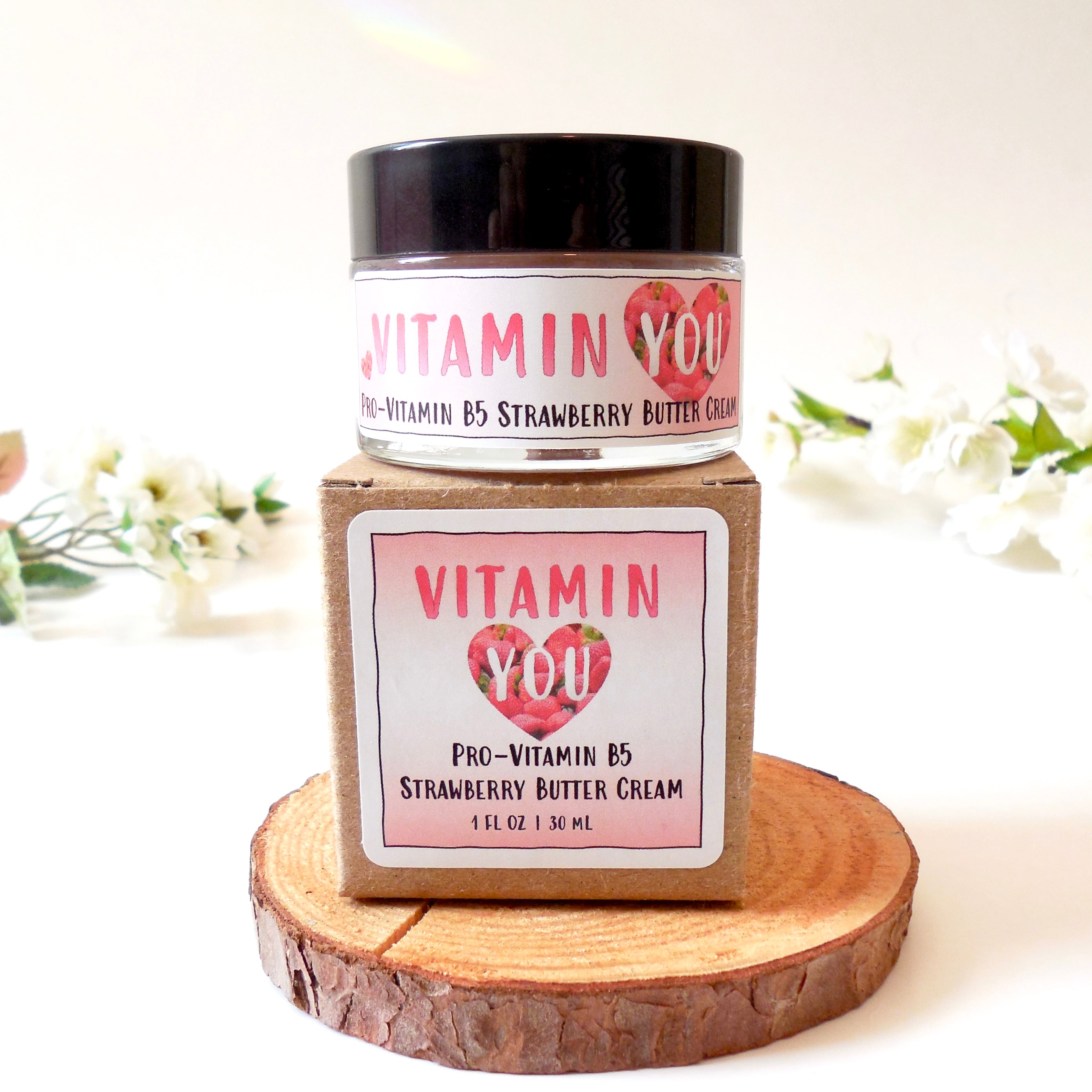 A jar and box of Vitamin You Vitamin B5 Strawberry Butter Cream that has a light pink and strawberries theme.