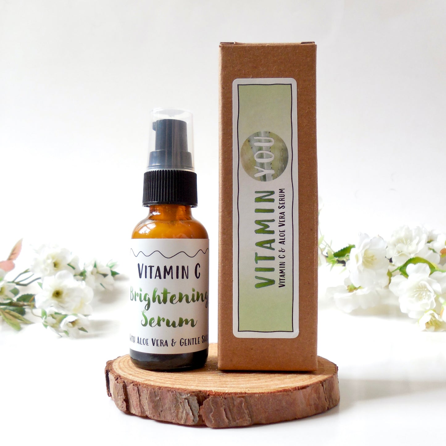 Bottle and box of the Vitamin You Vitamin C Brightening Serum with a white and light green theme