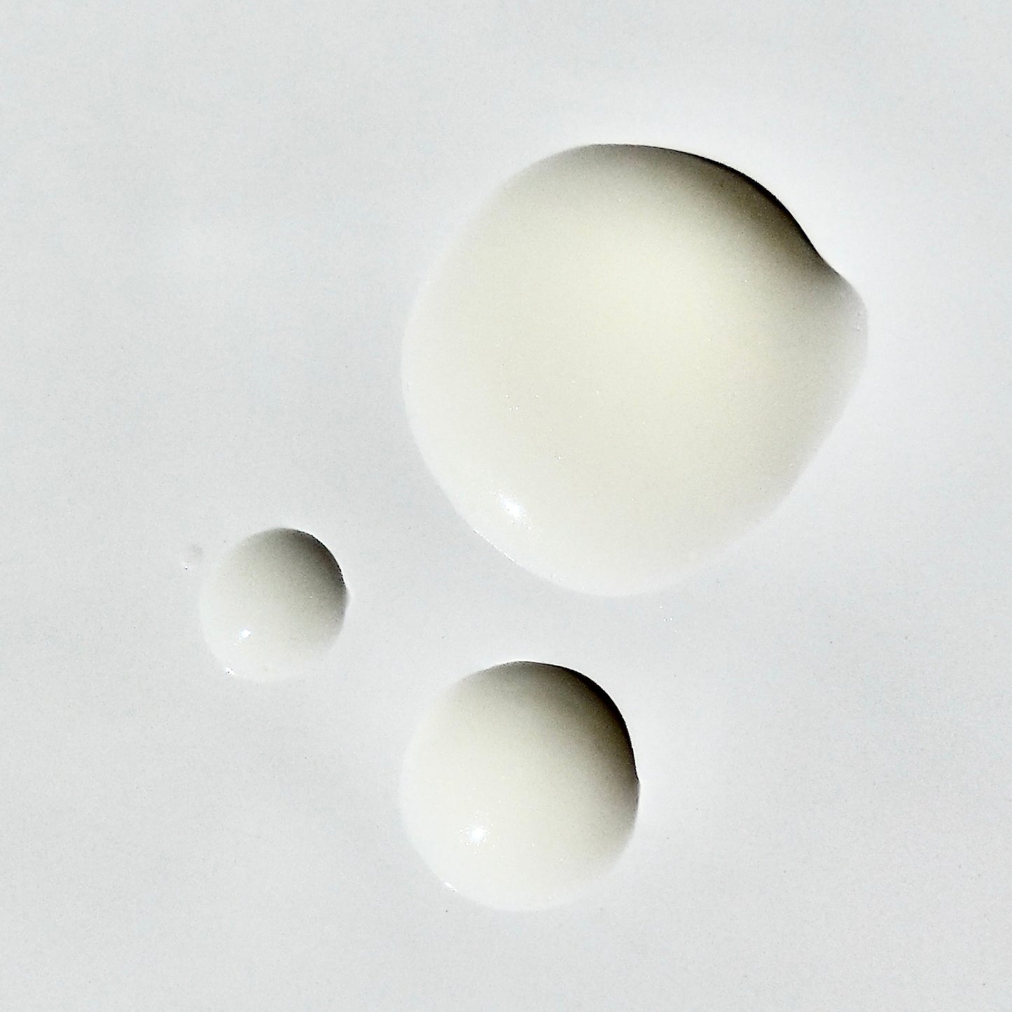 Close up droplets of the off-white Vitamin C Brightening Serum